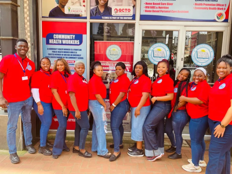 Kunokhanya team in red outside the community health centre