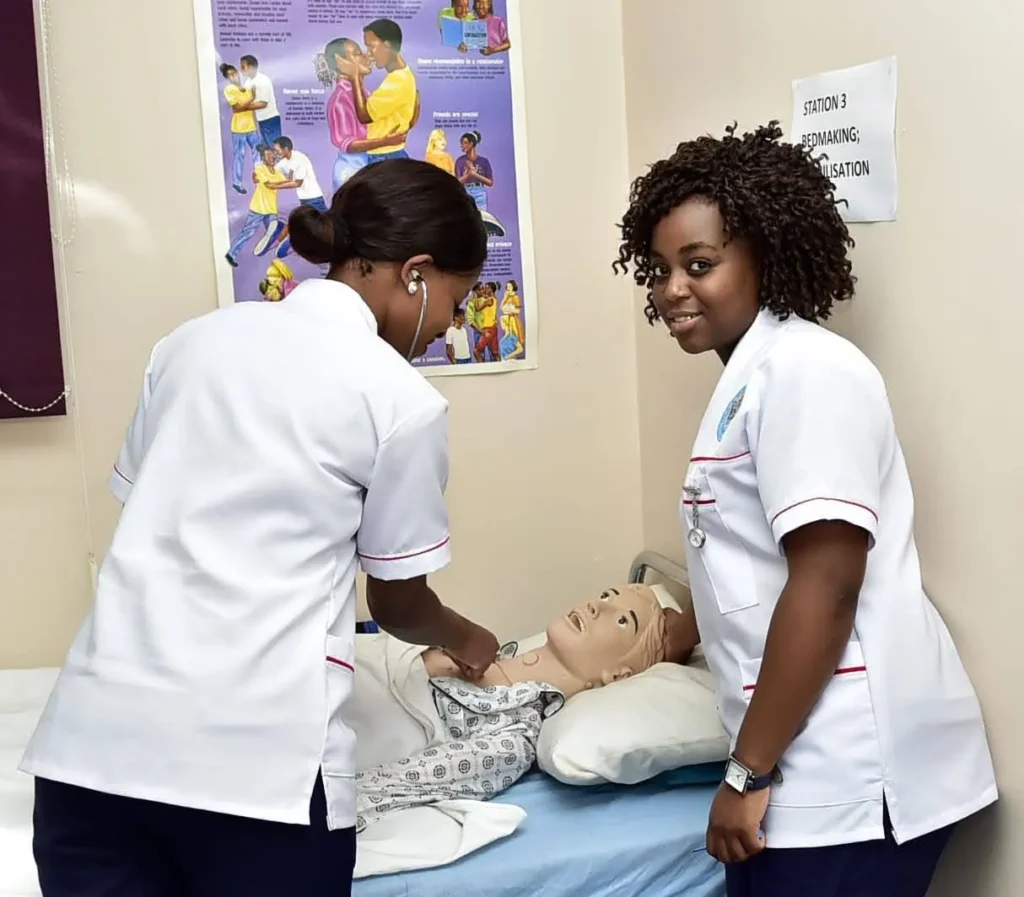 Learners practising care skills on a training manikin